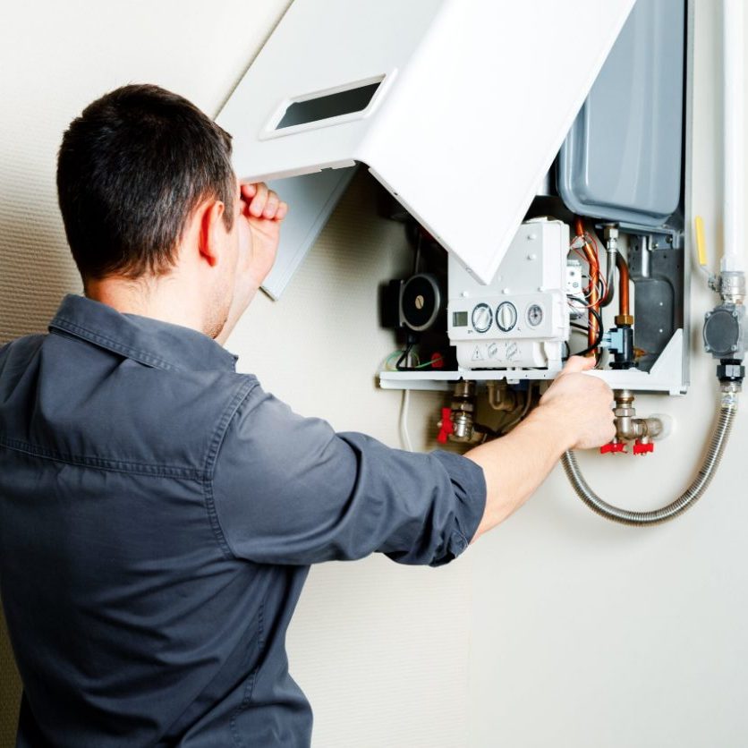 Gas man fixing gas boiler